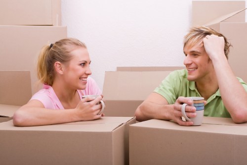 Trained movers carrying boxes with care and PPE