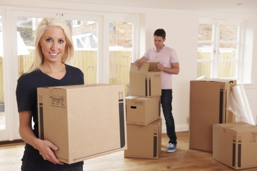Professional movers handling office furniture and boxes