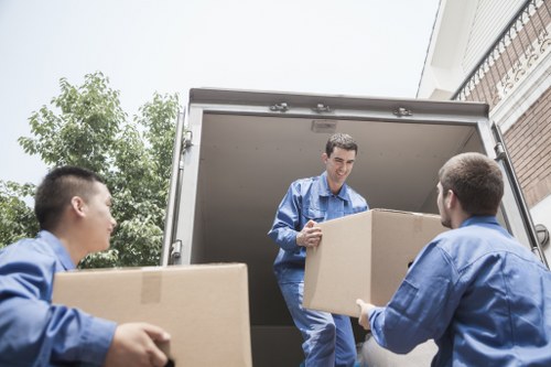 Local movers handling workstations during a commercial relocation in Maryland