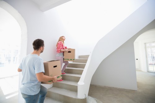 Local moving team preparing boxes near a Maryland townhouse entrance